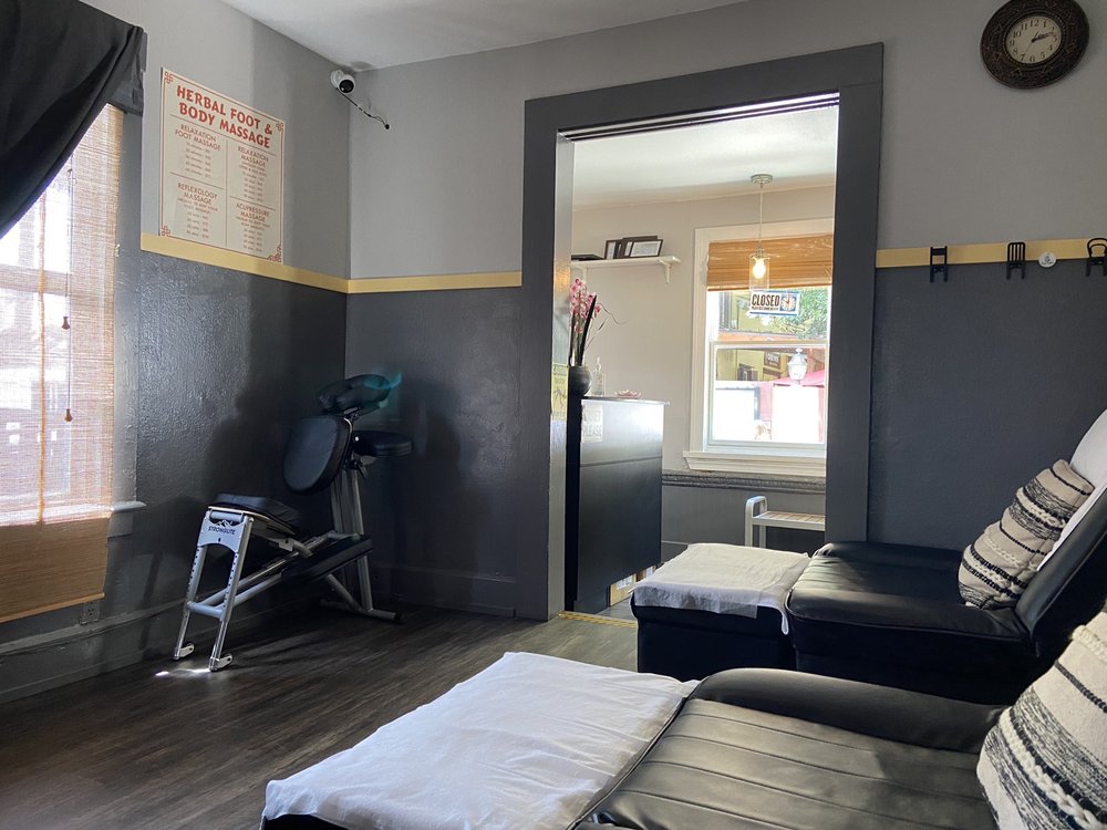 Our two-tone charcoal room, black reclining chairs with white towels, a Stronglite chair by the bamboo blinds