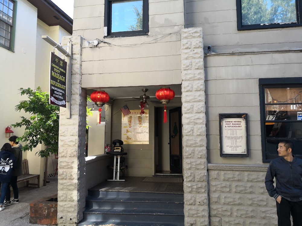 Our porch on Hypolita: hanging sign, red lanterns, coquina stone, the number 17 in the window