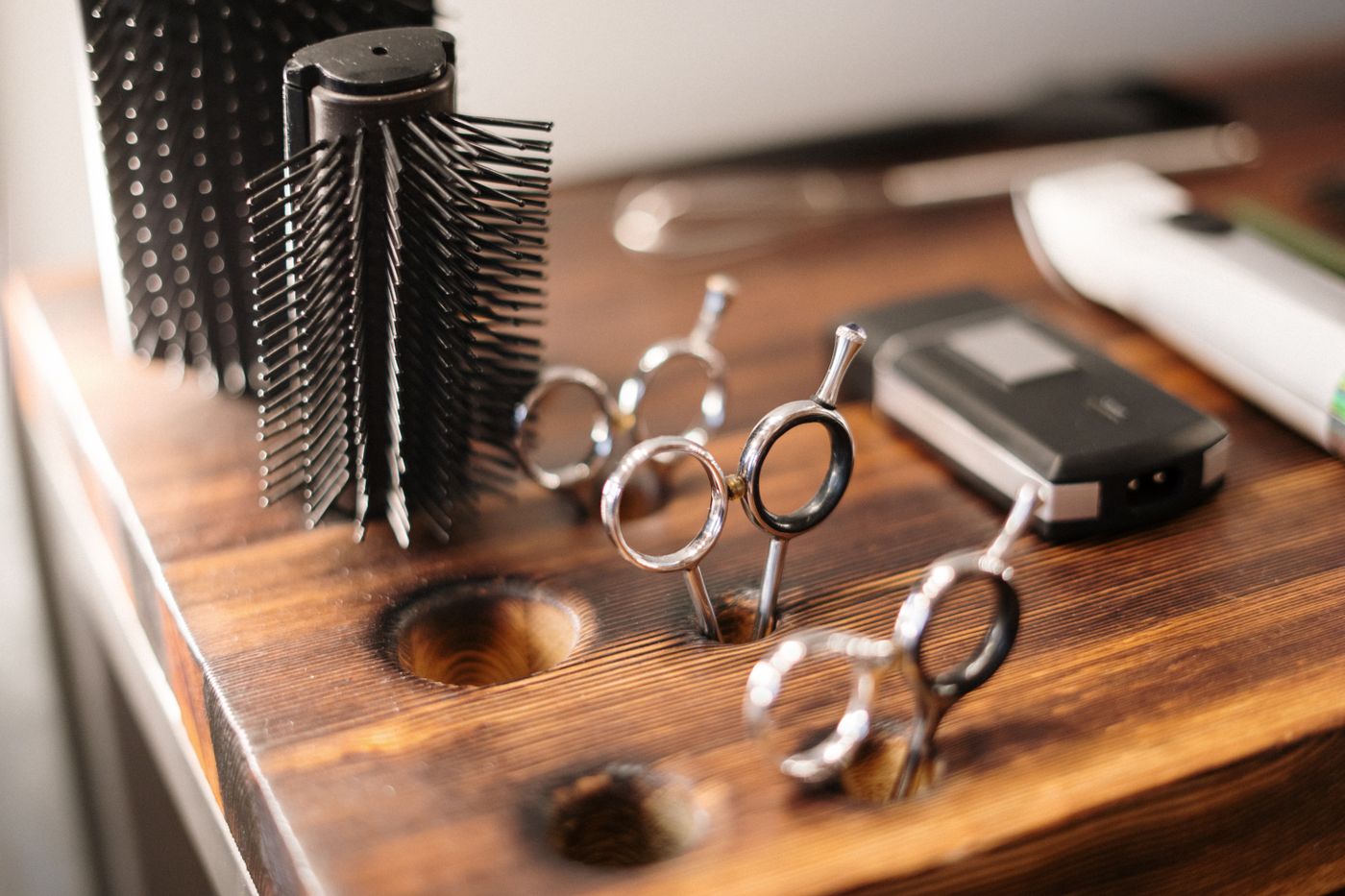 Clippers, shears, and a color whisk on the station.
