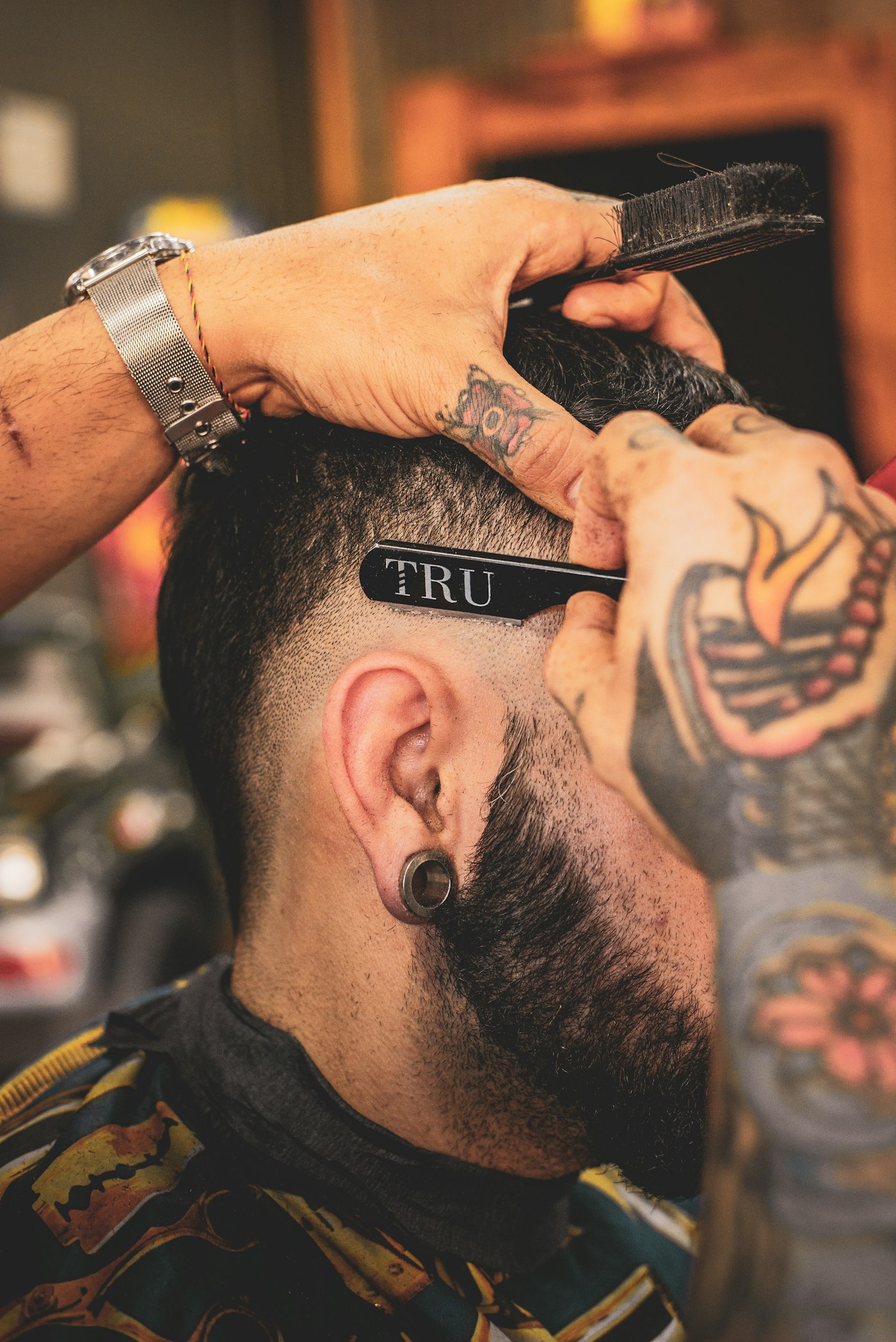A cut in progress, clippers at the temple.