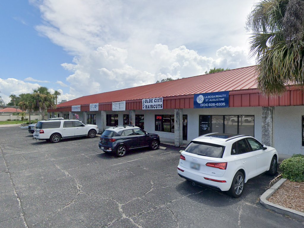 Our shop at Depot Plaza on N Ponce, red tin roof and the Olde City Haircuts sign