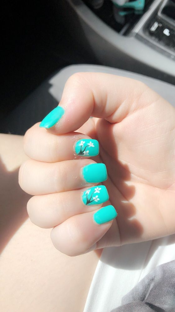 Short turquoise gel with white blossom art on two accent fingers.