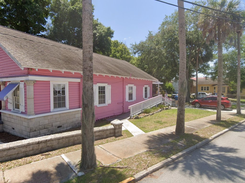 Our pink cottage, white trim, palms on San Marco.