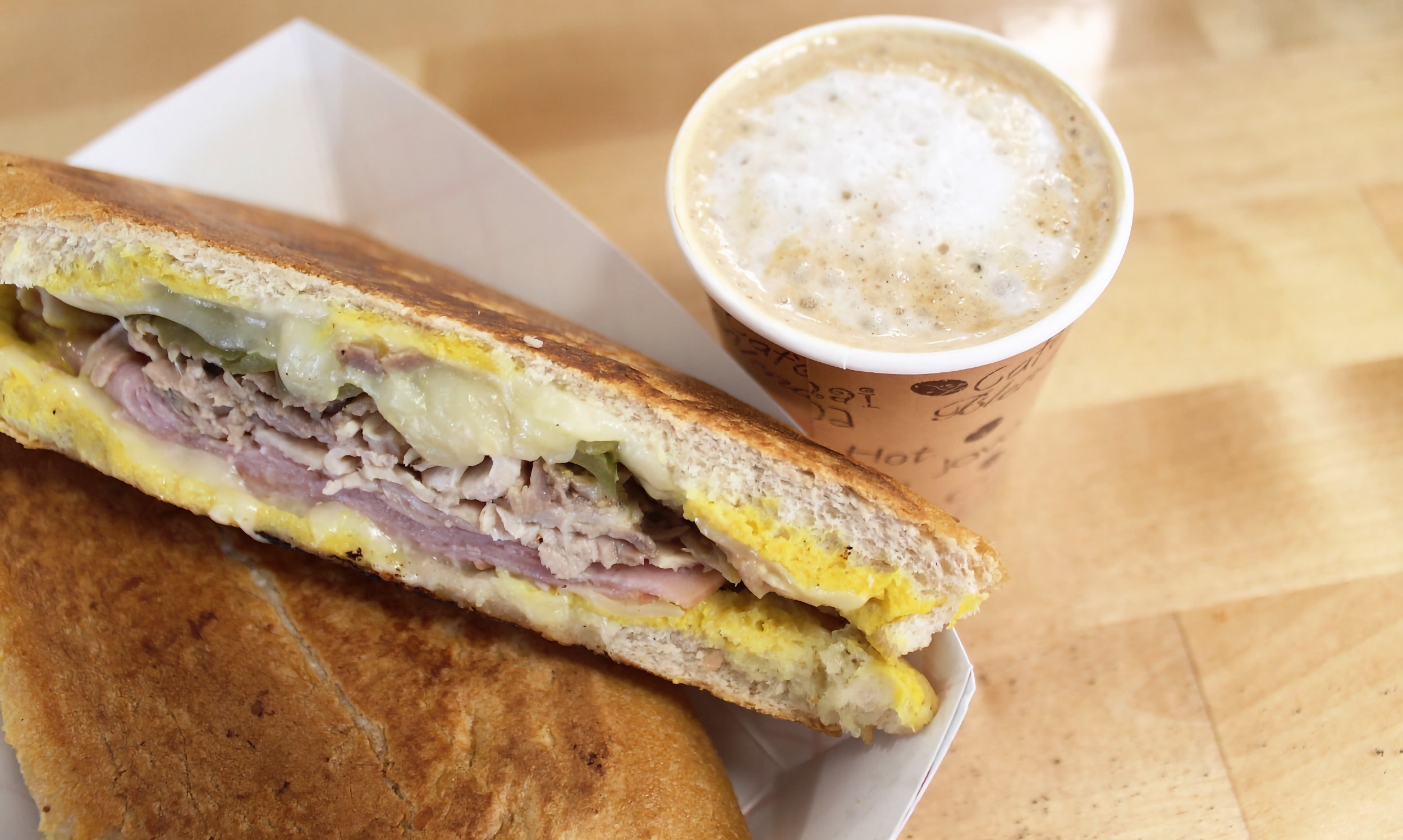 A pressed Cuban sandwich and cafe con leche from our counter