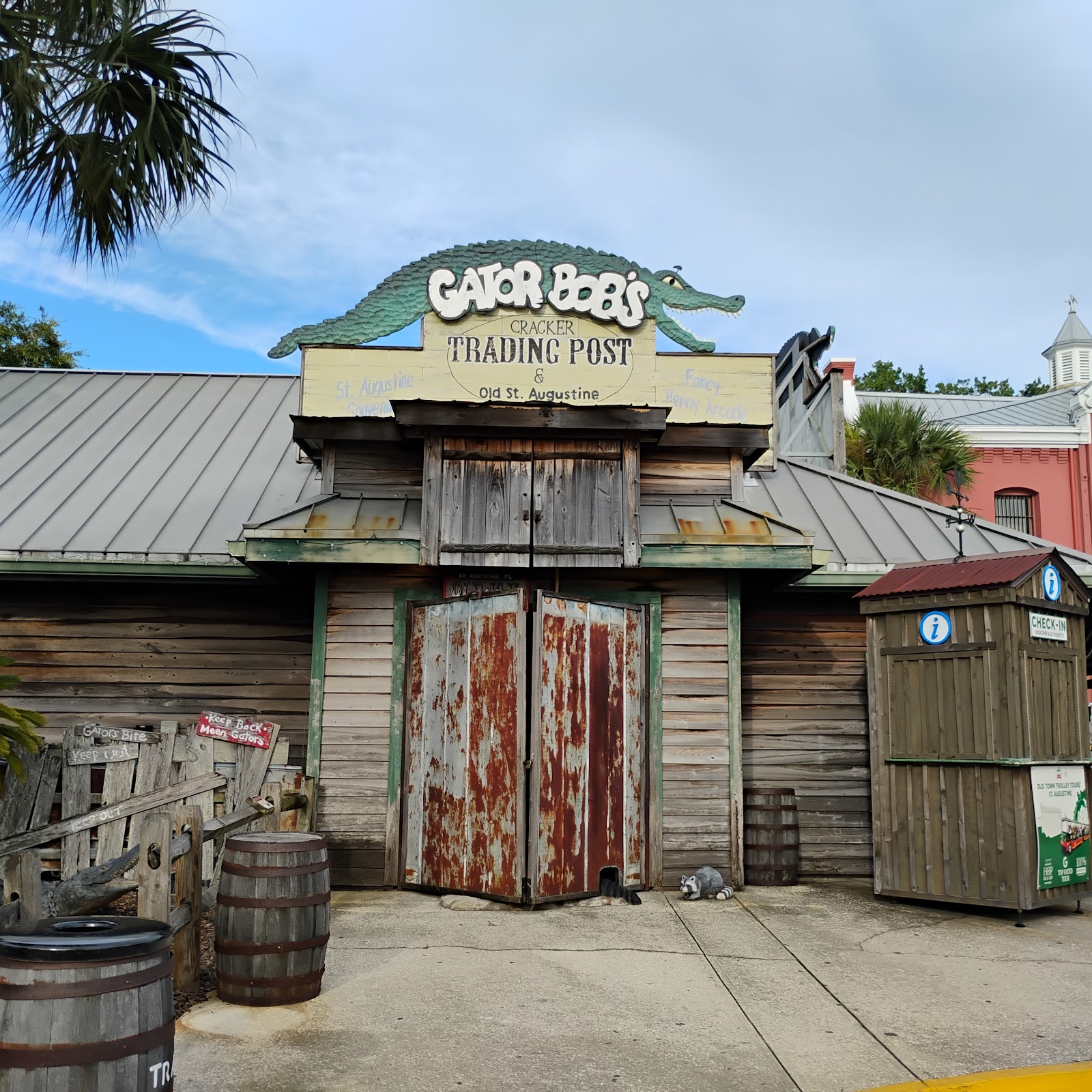 Our trading post on San Marco: rusted doors, gator sign, barrels out front