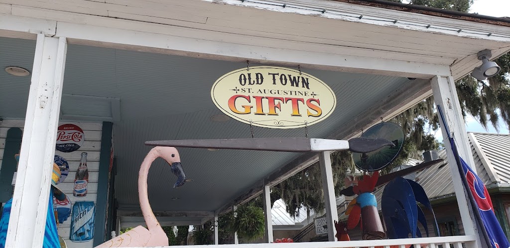 Old Town Gifts hanging sign, pink flamingo, and metal roosters
