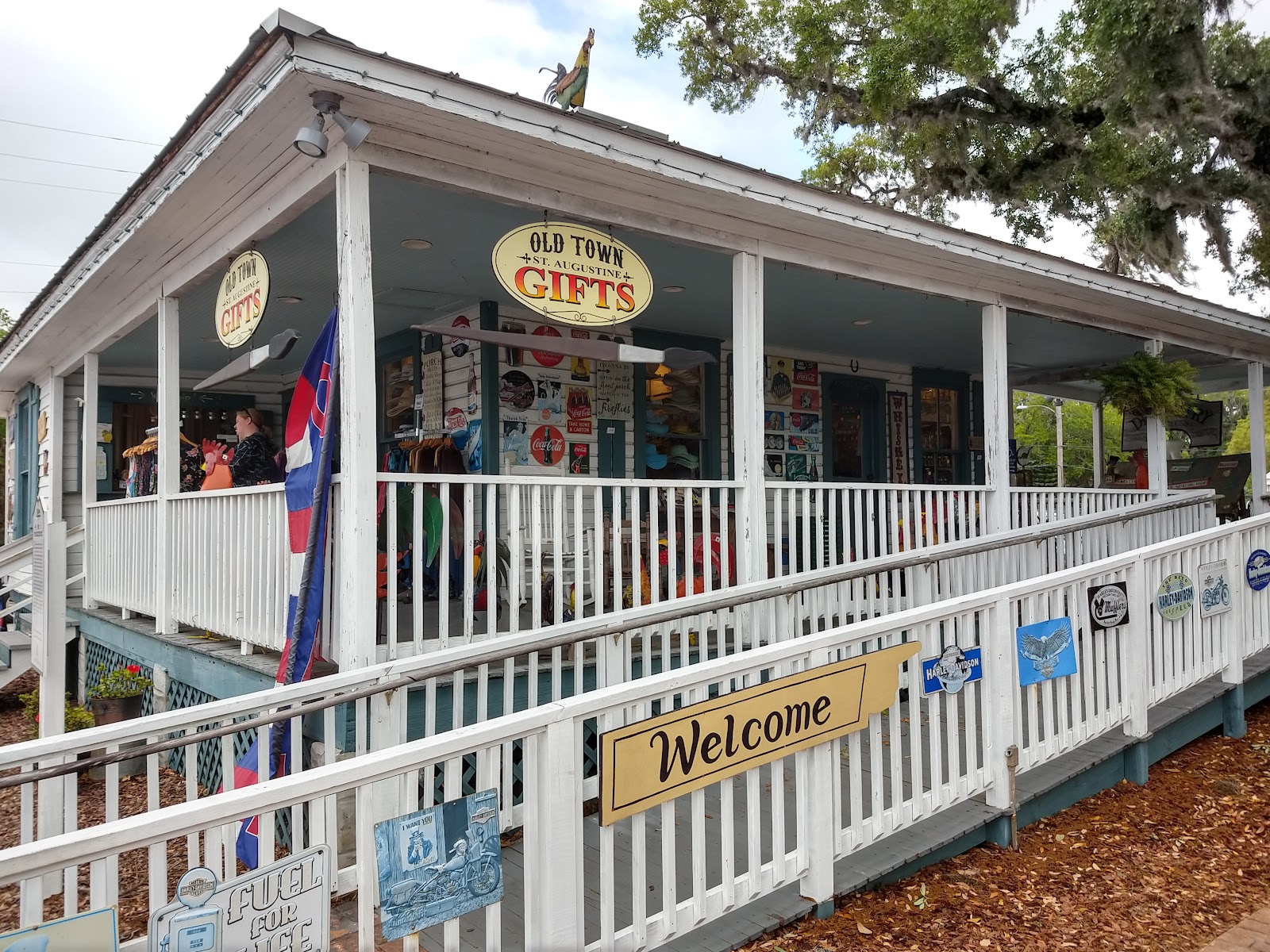 Our porch on San Marco: oval Old Town Gifts signs, metal plaques, hats, and shirts