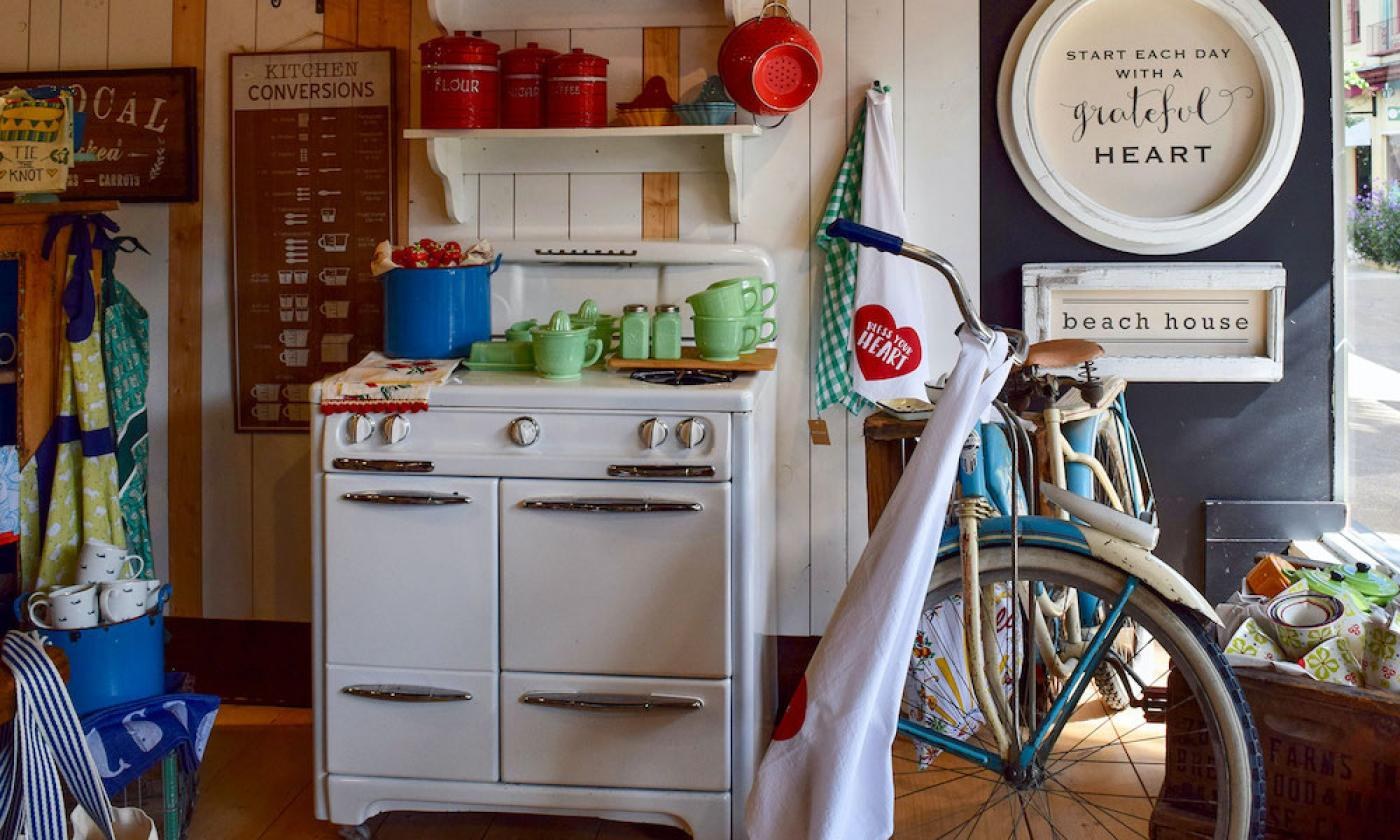 Our vintage stove display: jadeite kitchenware, literary signs, and the turquoise bicycle
