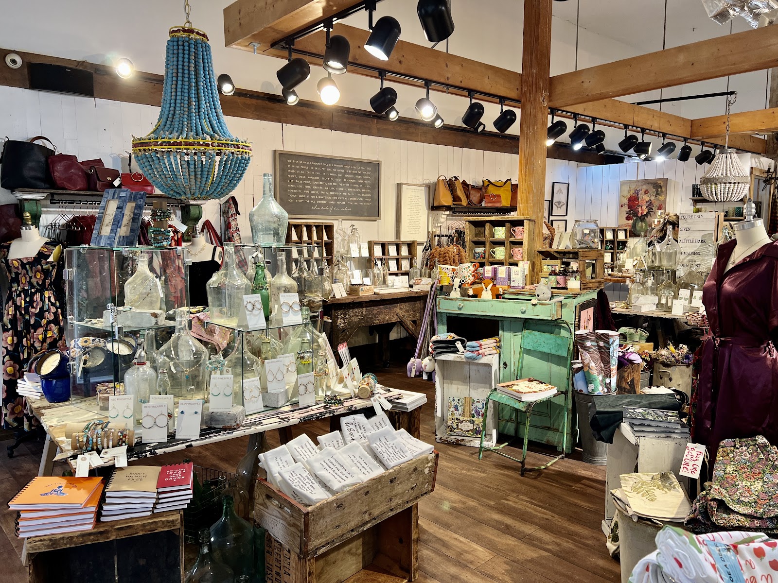 Our shop: turquoise beaded chandelier, wood beams, jewelry cases, and the green cabinet
