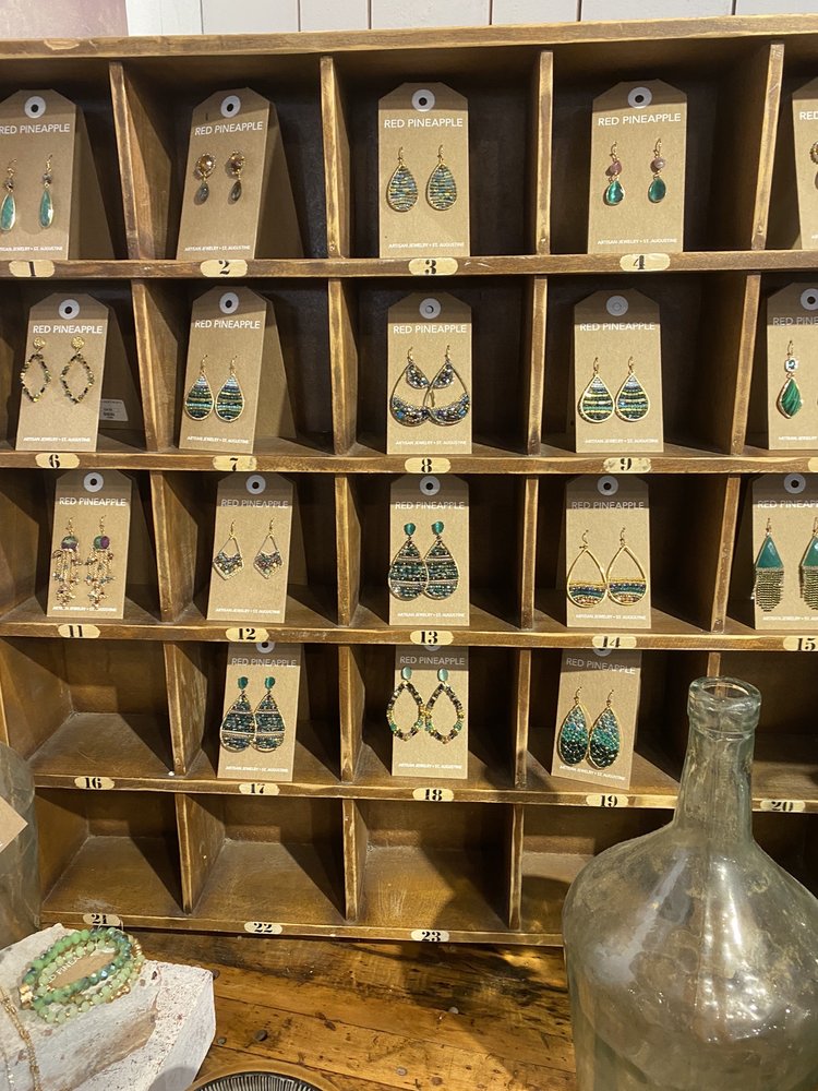 Numbered wood cubbies filled with Red Pineapple artisan earrings