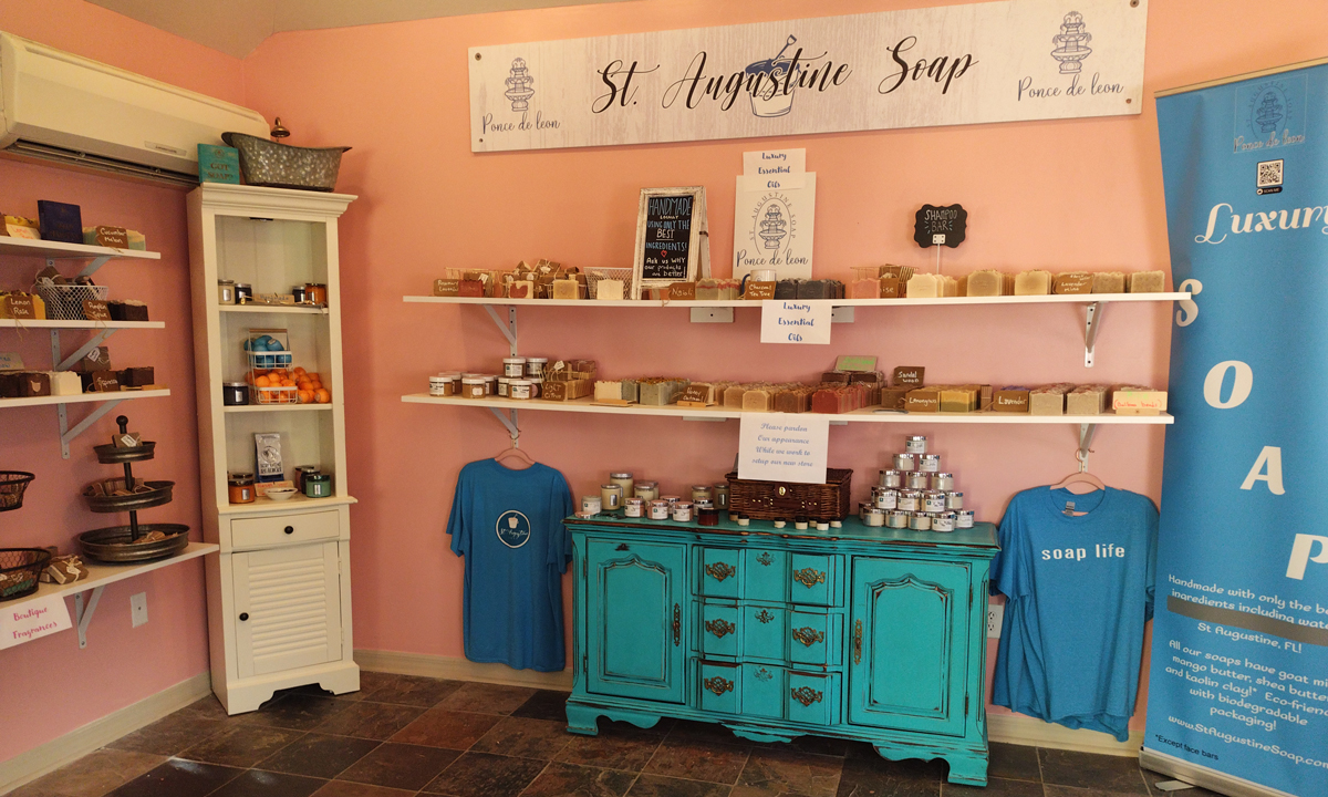 Our seafoam dresser and white shelves of bars and jars