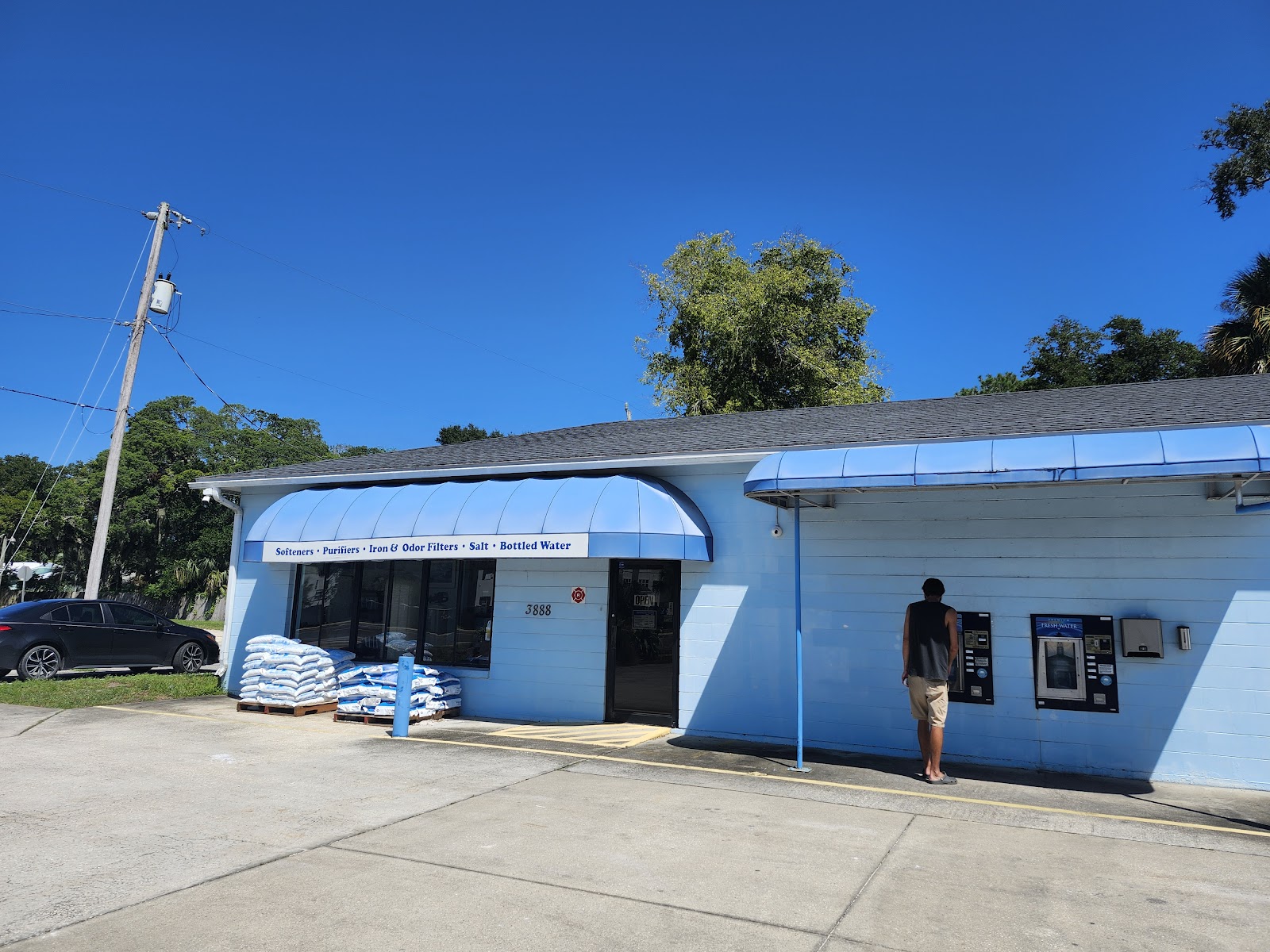 Our blue shop at 3888 N Ponce, with the fill windows under the awning and salt stacked on the lot