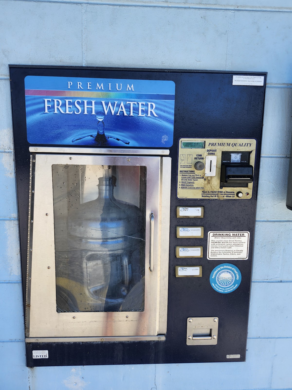 Our outdoor fill window with the gallon buttons and a jug in the chamber