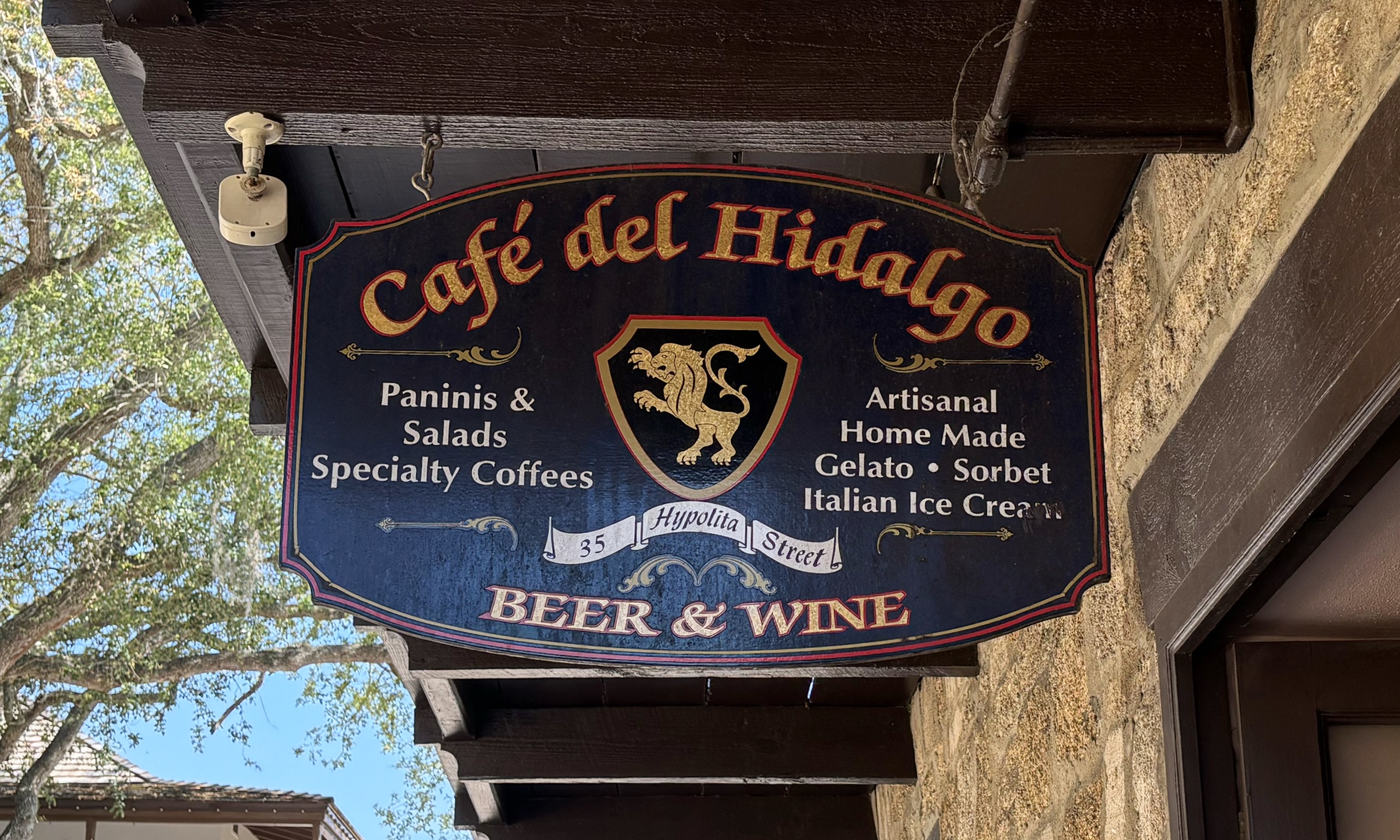 Our hanging oval sign for Café del Hidalgo at 35 Hypolita Street, with paninis, gelato, and beer and wine.