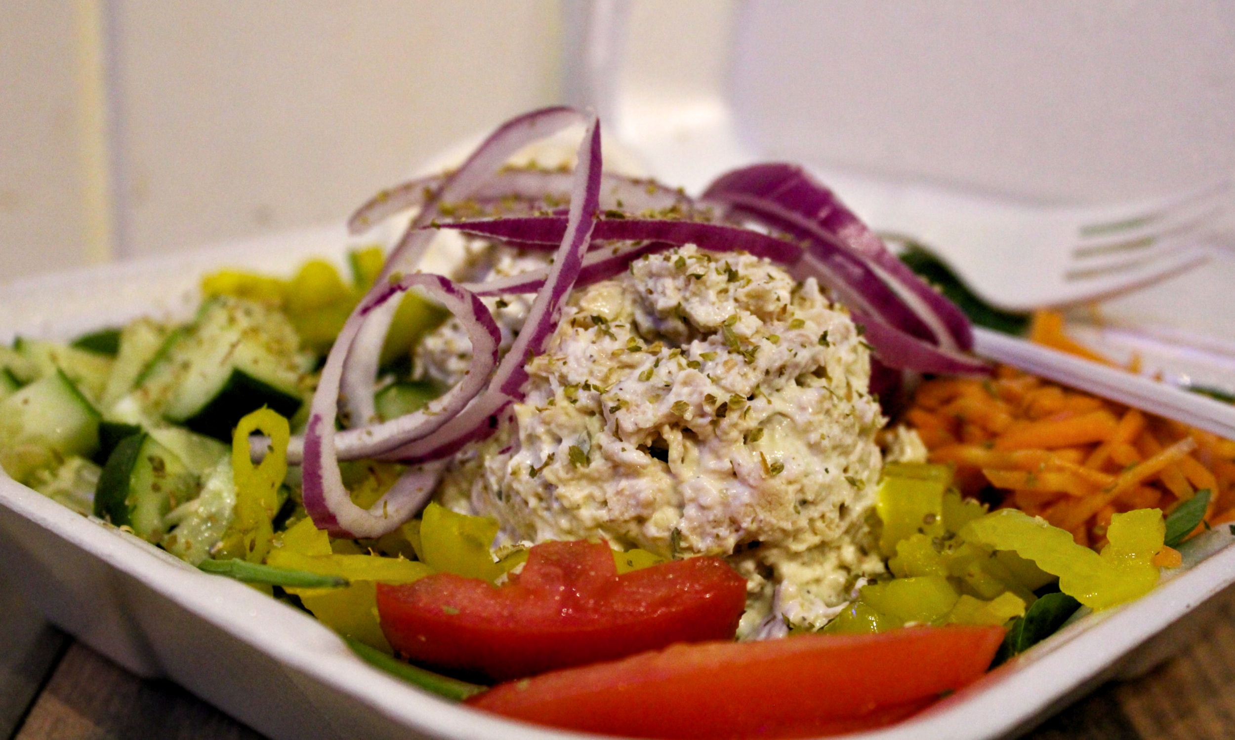 A salad from our board: herb chicken or tuna scoop, onion, tomato, cucumber, and carrots.