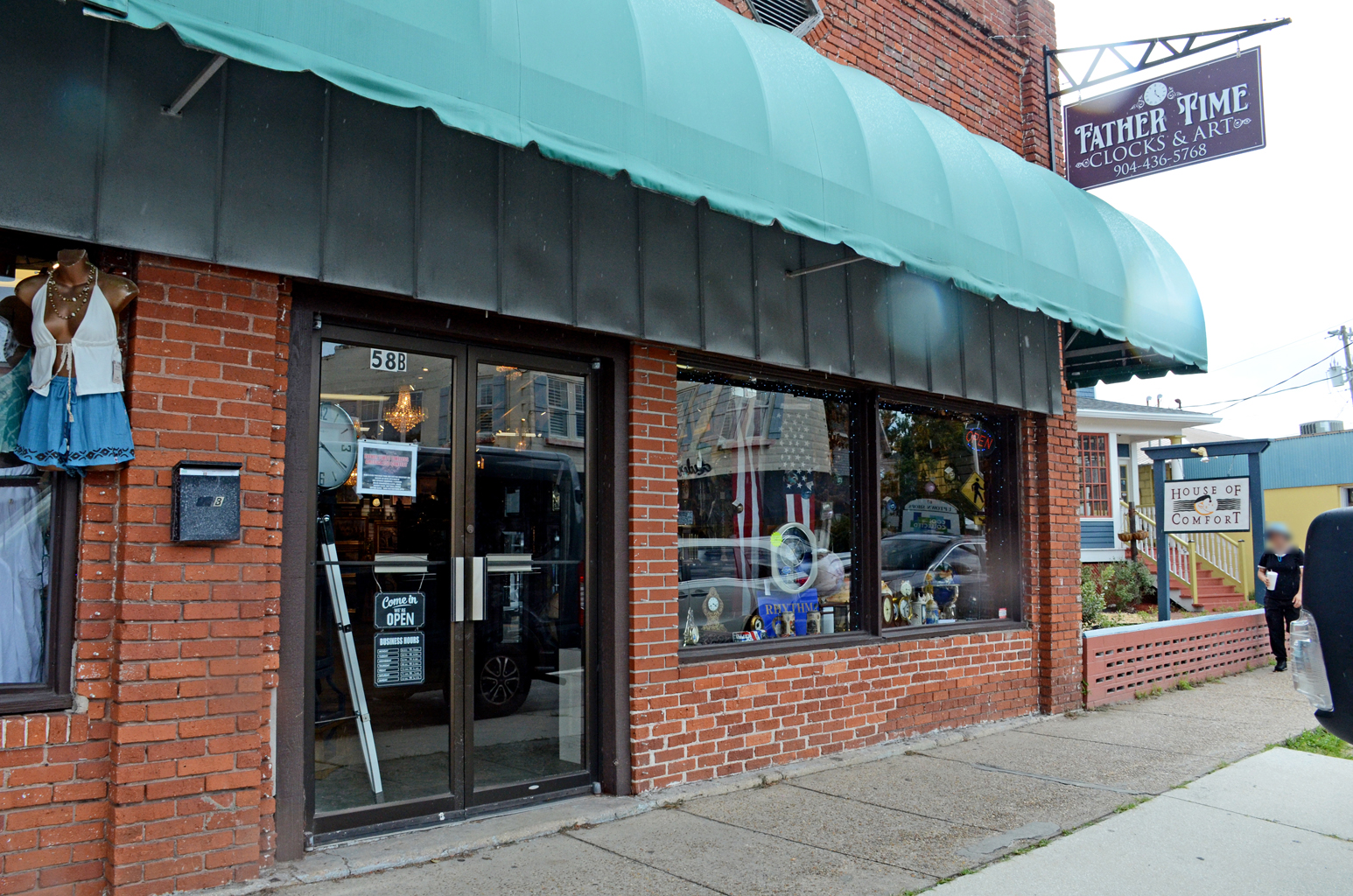Our 58-B San Marco shop: brick, green awning, and the Father Time Clocks and Art sign.