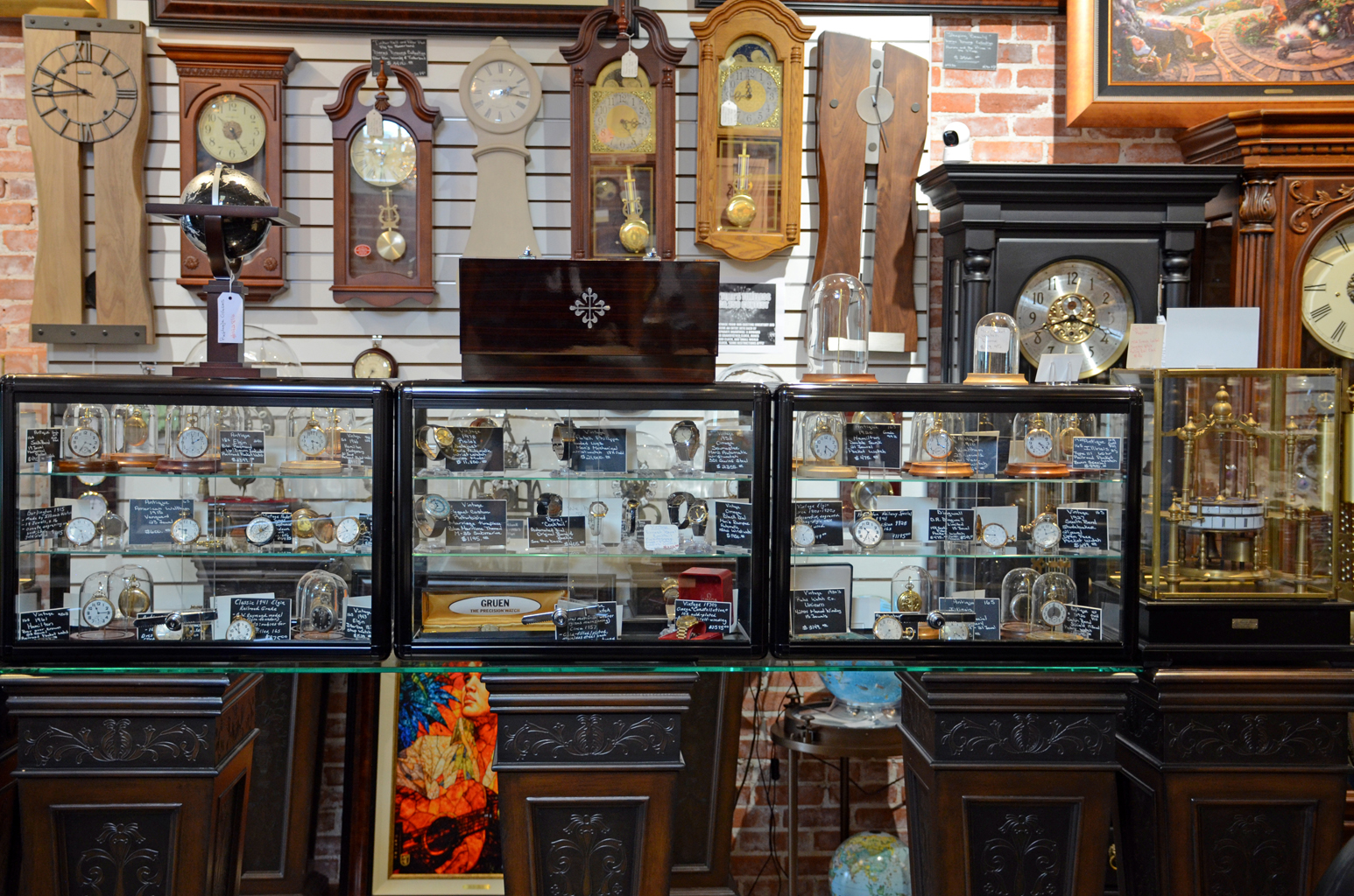 Glass cases of vintage pocket and wrist watches on our counter.