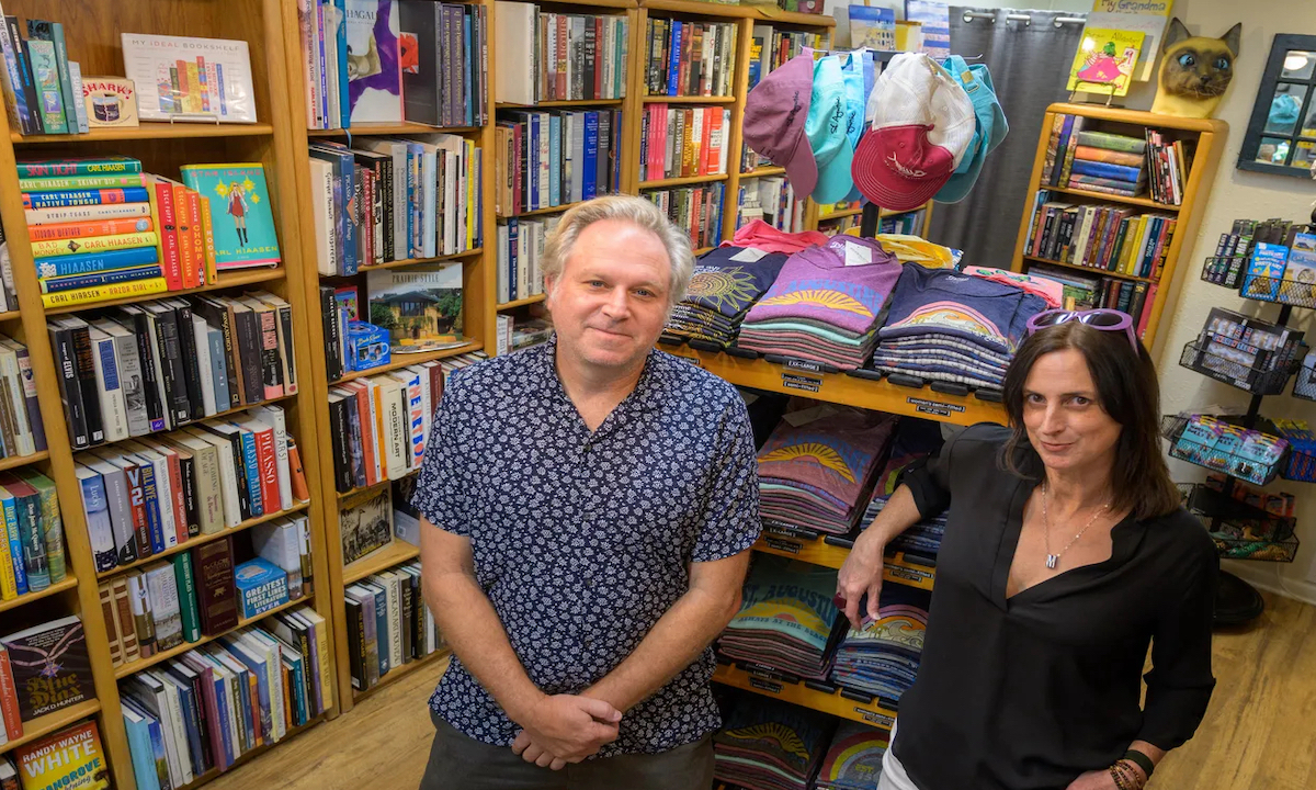 Inside our shop: bookshelves and stacked St Augustine shirts.
