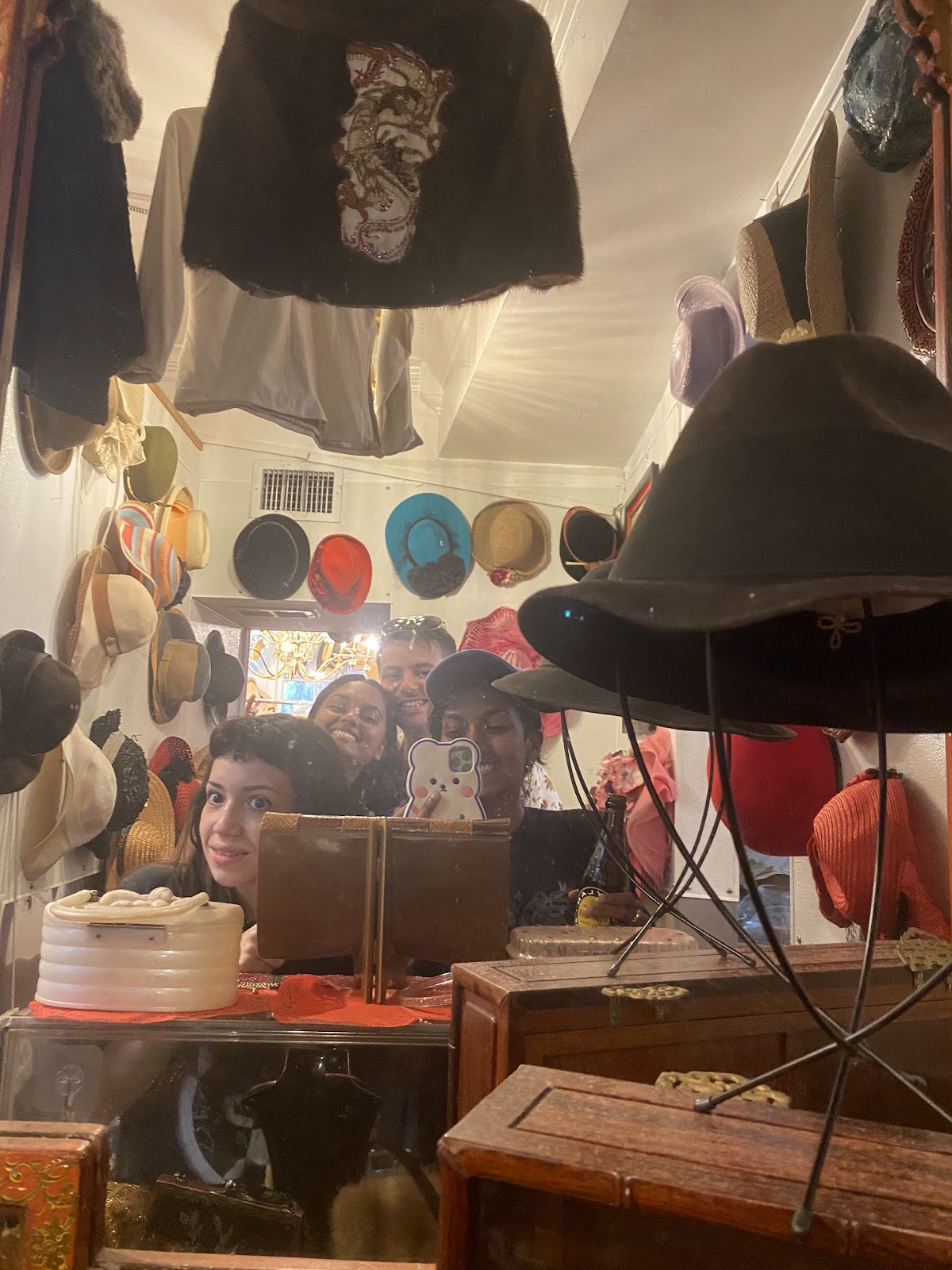 Hats hung on our walls, a felt brim on the stand, a vintage bag on the counter
