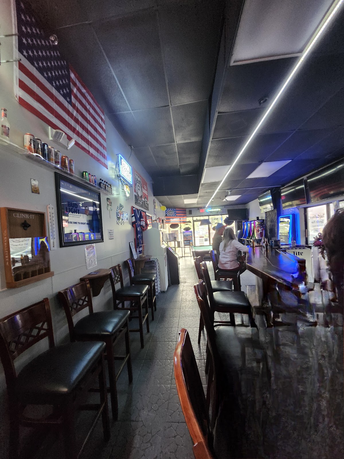 Our long wood bar, TVs, American flag, and the pool table at the back of Suite AA.