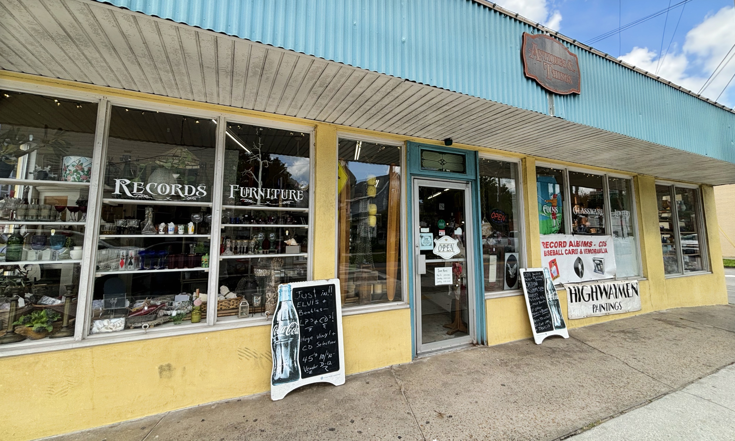 Our storefront at 62 San Marco Ave, with window lettering for records, coins, glassware, and jewelry.