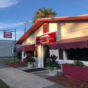 Drake's Bistro storefront on San Marco Avenue, maroon awnings and script sign