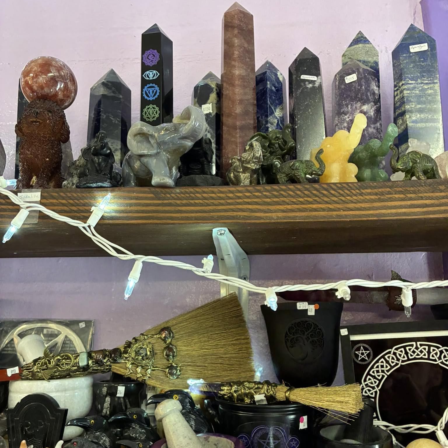 Crystal towers and altar tools on lavender walls