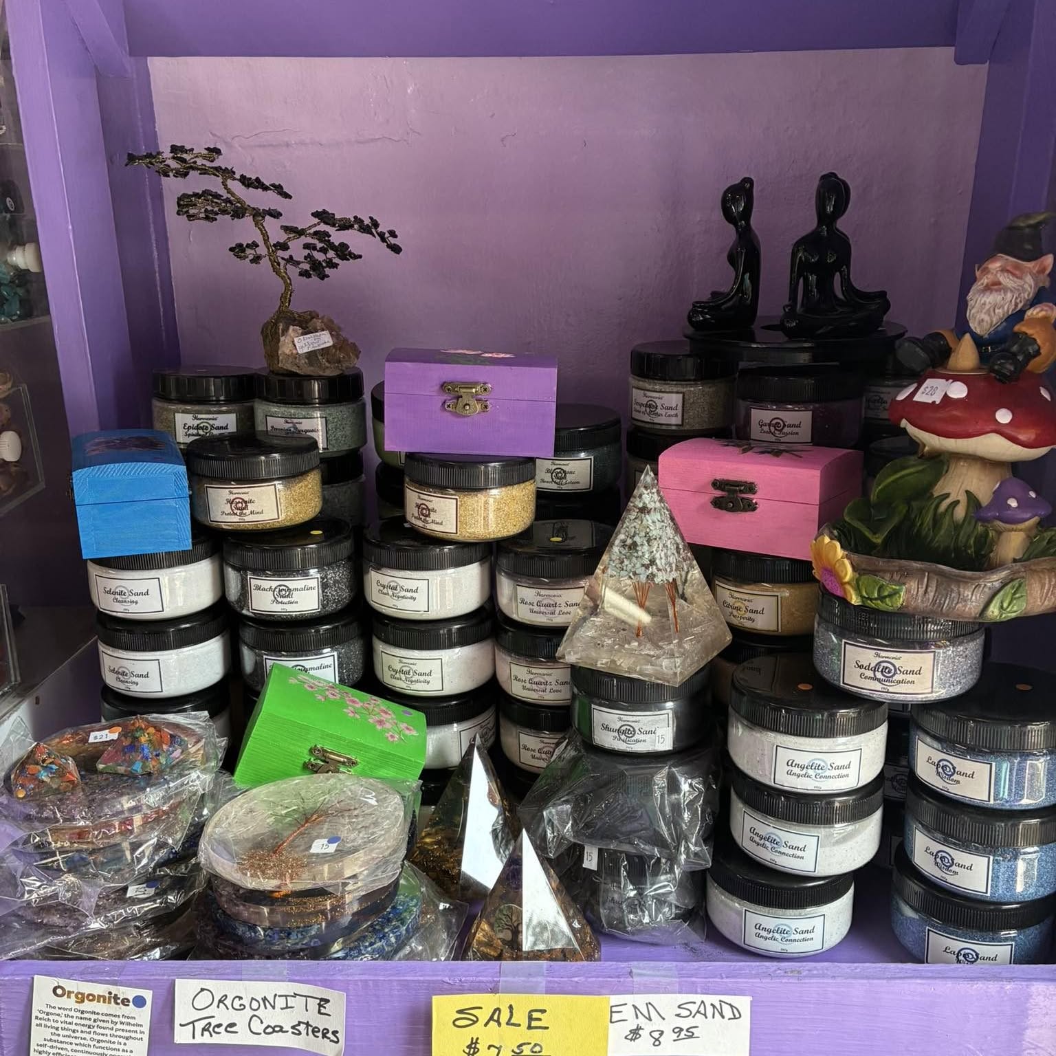 Gem sands and orgonite on a purple shelf