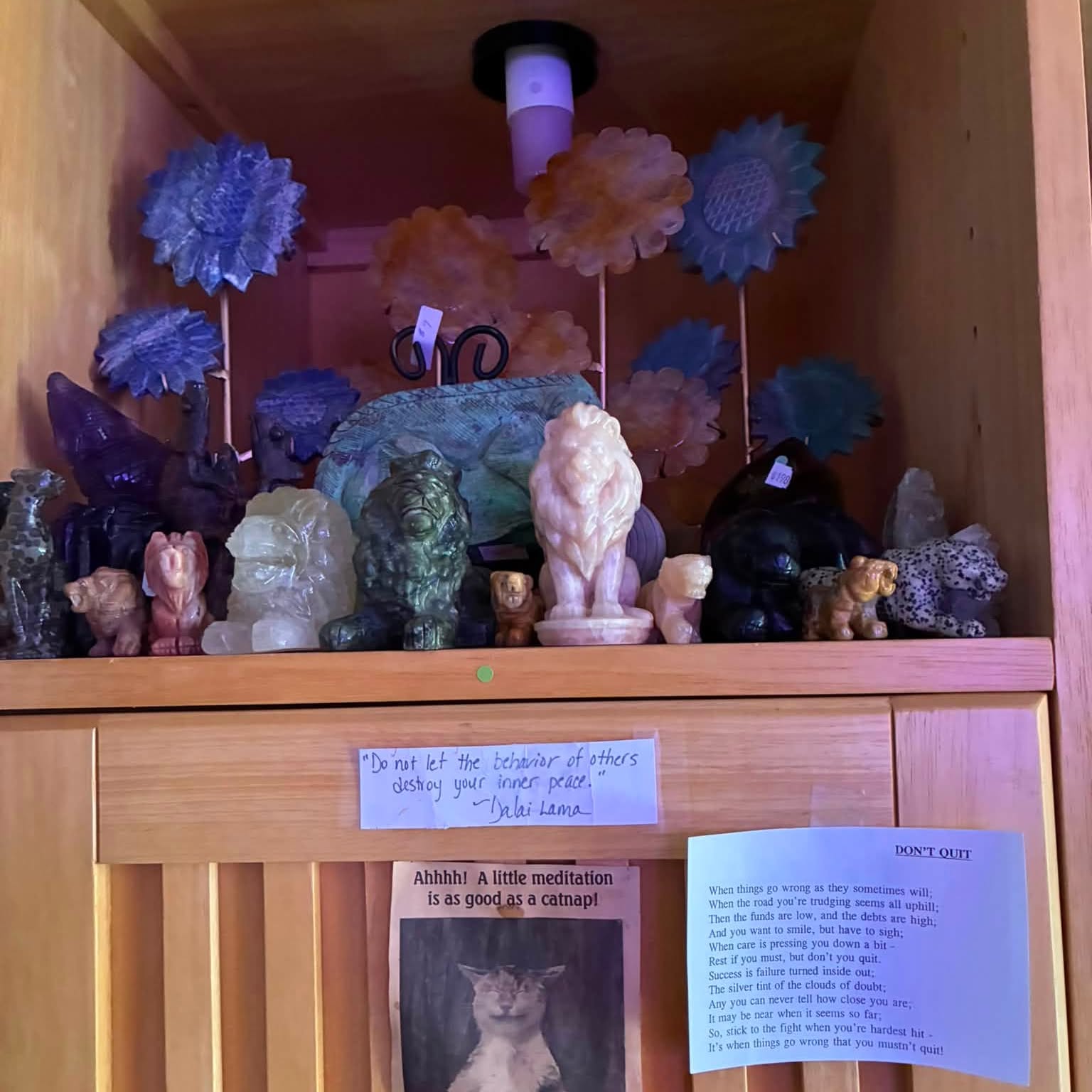 Stone animals and crystal flowers on our shelf