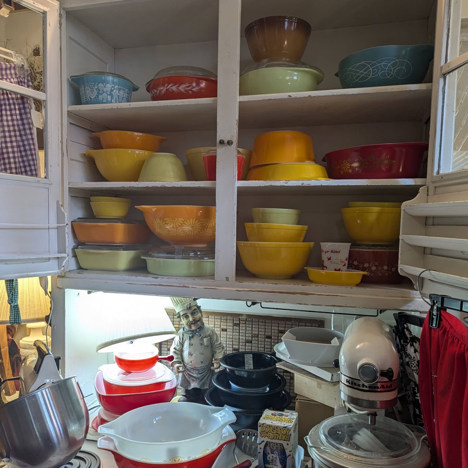 Our Pyrex bowls, casseroles, and mixer on the shelves.