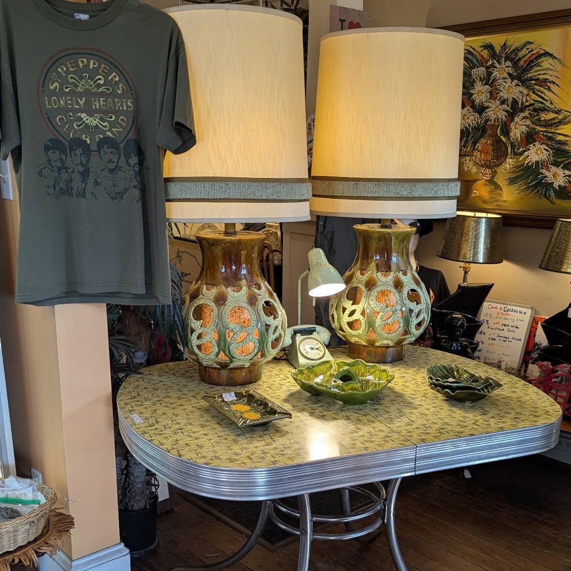Mid-century table, ceramic lamps, and green glass we set out.