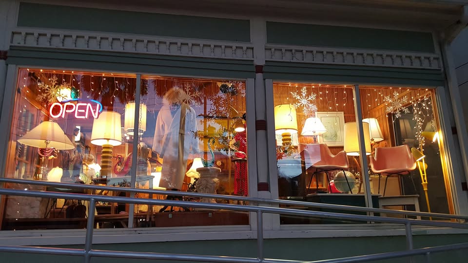 Our windows at night, lamps on, OPEN sign lit.