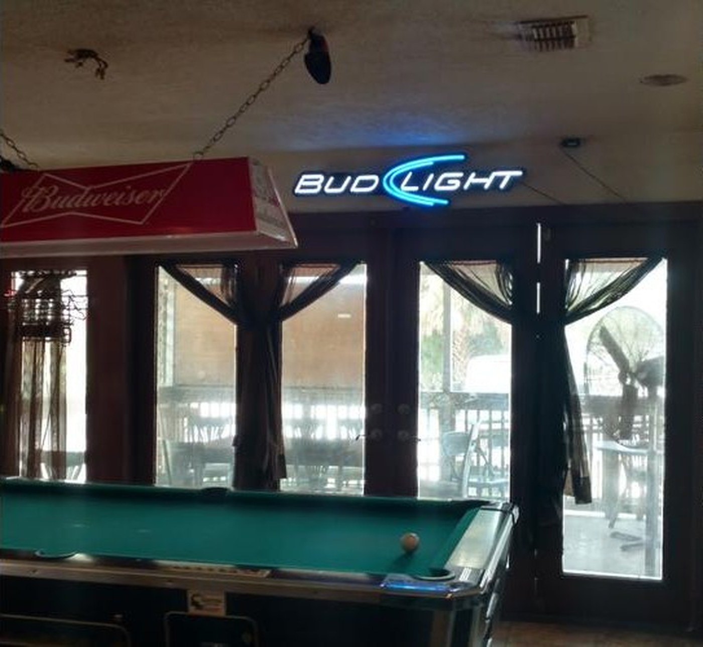 Our pool table under the hanging Budweiser lamp