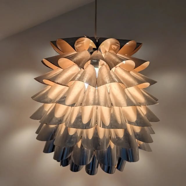 Artichoke pendant lamp hanging against our wall.