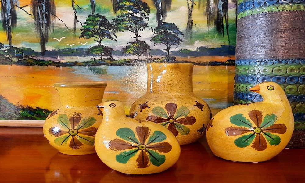 Mustard yellow ceramic birds and vases with flower glaze.