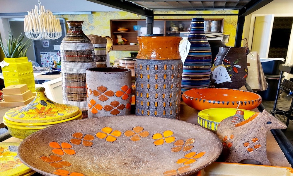 Italian ceramics on our table: mustard bowls, striped vases, and a ceramic horse.