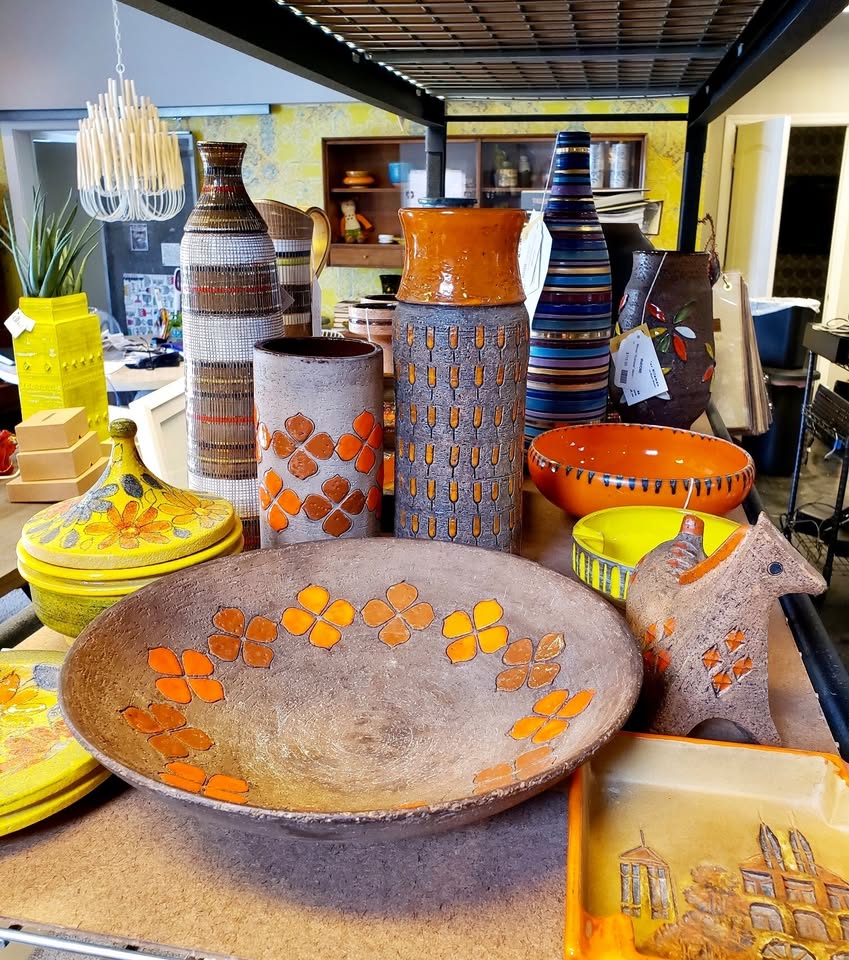 Italian ceramics on our table: mustard bowls, striped vases, and the yellow cabinet behind.