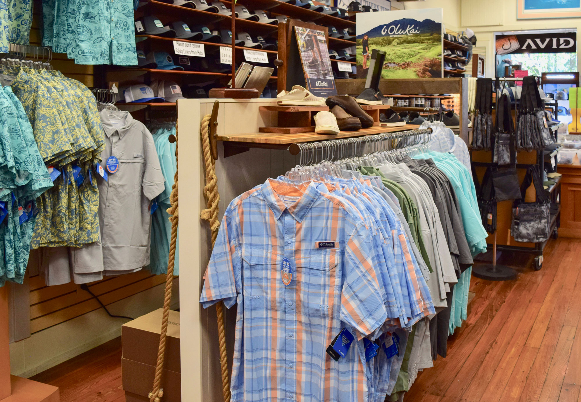 Our floor: Columbia PFG shirts on a rail, OluKai shoes on a wood shelf, and a manila rope around the pillar.