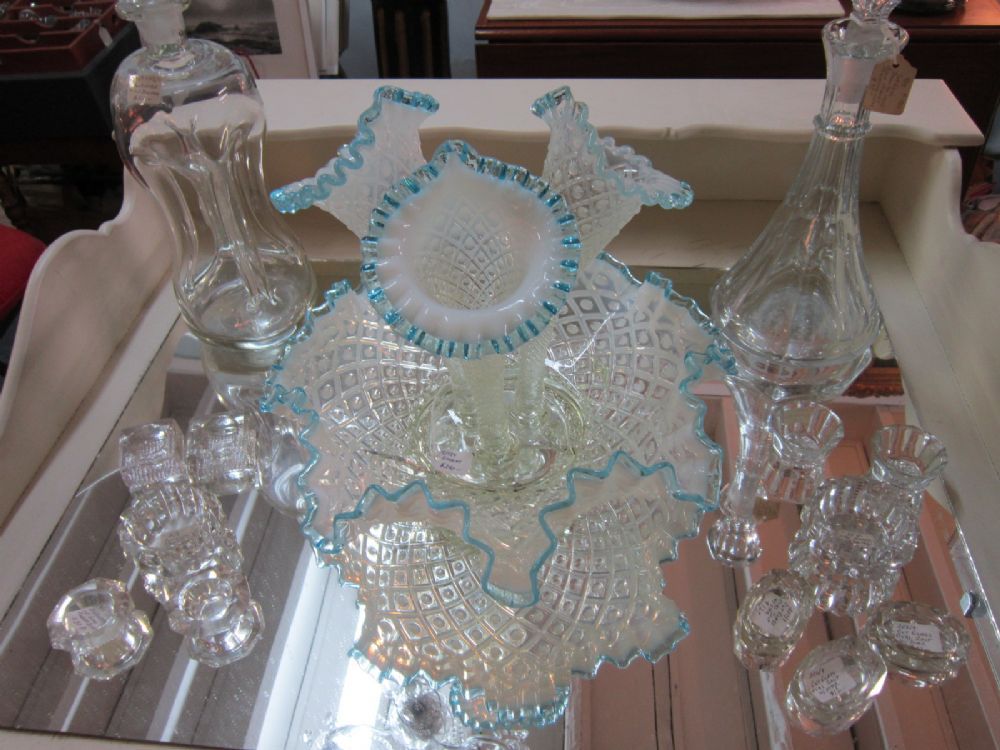Opalescent glass and crystal on a mirrored shelf in our room.