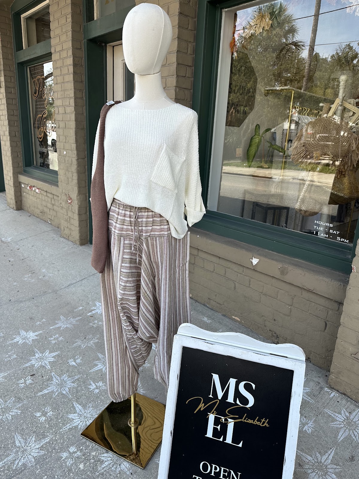 Our sidewalk at 215 W King. Mannequin, A-frame, forest-green window frames.