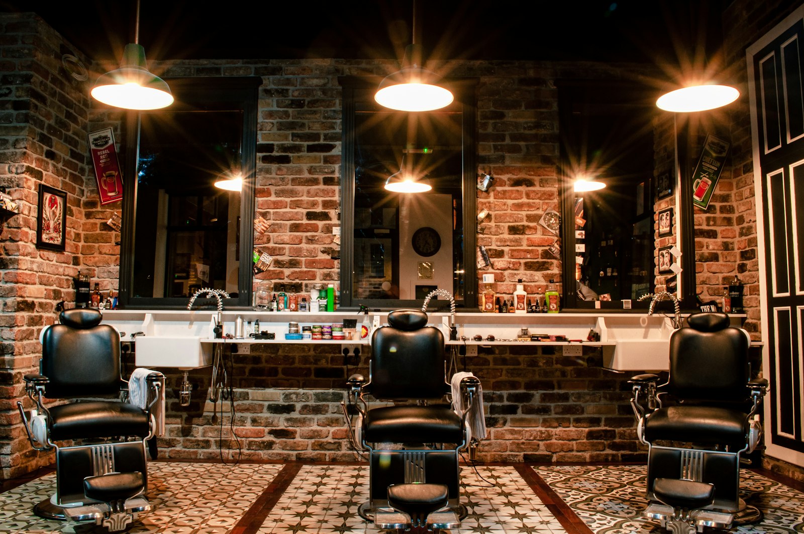 Classic chrome and leather barber chairs at a three-station shop.